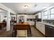 Updated kitchen with white cabinets, wood island, and view to dining area at 1404 Cassville Nw Rd, Cartersville, GA 30121