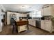 Updated kitchen with white cabinets, wood island, and view to dining area at 1404 Cassville Nw Rd, Cartersville, GA 30121