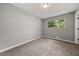 Spacious bedroom with neutral gray walls and carpeted floor at 1730 Salina Dr, Jonesboro, GA 30236