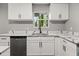 White shaker cabinets, quartz countertops, and a farmhouse sink at 1730 Salina Dr, Jonesboro, GA 30236