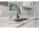 Close-up of kitchen sink with modern faucet and quartz countertop at 1730 Salina Dr, Jonesboro, GA 30236