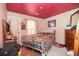 Cozy bedroom with wooden furniture, an animal print bedspread, and unique ceiling decor at 10359 Briarbay Loop, Jonesboro, GA 30238