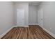 Well-lit bedroom with wood-look flooring and ample closet space at 469 Omnia Ridge Way, Lawrenceville, GA 30044