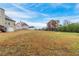 Large backyard with partial fence, and view of neighborhood at 1032 Richmond Place Way, Loganville, GA 30052