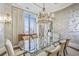 Formal dining room featuring a glass table, chandelier, and wallcovering at 3376 Peachtree Ne Rd # 47A, Atlanta, GA 30326