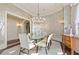 Formal dining room with glass table, chandelier, and scenic wallpaper at 3376 Peachtree Ne Rd # 47A, Atlanta, GA 30326
