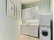 Laundry room with stacked washer and dryer and white cabinets at 3376 Peachtree Ne Rd # 47A, Atlanta, GA 30326
