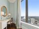 Bright vanity area with a large mirror and city views at 3376 Peachtree Ne Rd # 47A, Atlanta, GA 30326