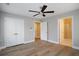 Bedroom with hardwood floors, ceiling fan, and en-suite bathroom at 5359 Megan Rd, Stone Mountain, GA 30088