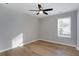 Bright bedroom featuring hardwood floors and ceiling fan at 5359 Megan Rd, Stone Mountain, GA 30088