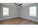 Bright bedroom with hardwood floors and two windows at 5359 Megan Rd, Stone Mountain, GA 30088