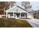 Gray house with white columns, front porch, and a two-car garage at 5359 Megan Rd, Stone Mountain, GA 30088