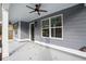 Front porch detail with ceiling fan and gray siding at 5359 Megan Rd, Stone Mountain, GA 30088