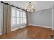 Bright dining room with hardwood floors, plantation shutters, and modern light fixture at 212 Mcaffee St, Woodstock, GA 30188