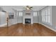 Inviting living room with fireplace, hardwood floors, and ample natural light at 212 Mcaffee St, Woodstock, GA 30188