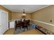 Dining area with wooden table and chairs, neutral color scheme at 6900 Roswell Rd # N9, Atlanta, GA 30328