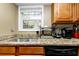 Kitchen sink and countertop with black appliances at 6900 Roswell Rd # N9, Atlanta, GA 30328