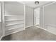 Cozy bedroom with built-in shelving and neutral wall at 3665 Sharon Dr, Powder Springs, GA 30127