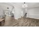 Open dining room with wood-look tile floors, and view into kitchen at 3665 Sharon Dr, Powder Springs, GA 30127