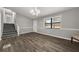 Bright entryway with wood-look floors, stairs, and a large window at 3665 Sharon Dr, Powder Springs, GA 30127