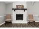 Stone fireplace with a wooden mantel in a living room at 3665 Sharon Dr, Powder Springs, GA 30127