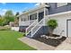 Charming front porch with white railings, a porch swing, and lush landscaping at 3665 Sharon Dr, Powder Springs, GA 30127