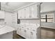 White kitchen cabinets with quartz countertops and view to dining area at 3665 Sharon Dr, Powder Springs, GA 30127