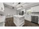 Open kitchen with white cabinets and a large island at 3665 Sharon Dr, Powder Springs, GA 30127