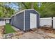 Large storage shed with white door and window at 3665 Sharon Dr, Powder Springs, GA 30127