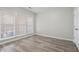 Bright bedroom with three windows and wood-look floors at 4830 Payson Se Pl # 29, Atlanta, GA 30339