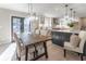 Open concept dining room with a farmhouse table and pendant lighting at 6856 Womack Ct, Peachtree Corners, GA 30360