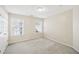 Well-lit bedroom with neutral walls, carpet and two windows at 589 Lantern Wood Dr, Scottdale, GA 30079