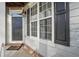 Gray front door with dark shutters and a welcoming porch at 589 Lantern Wood Dr, Scottdale, GA 30079