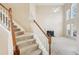 Carpeted staircase with wooden railing at 589 Lantern Wood Dr, Scottdale, GA 30079