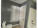 Bathroom with tub, toilet and gray walls at 106 Ellis Dr, Conyers, GA 30012