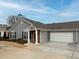 Gray siding house with brick accents, attached garage, and manicured landscaping at 244 Camry Cir, Dallas, GA 30157