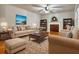 Spacious living room featuring hardwood floors, built-in shelving, and a brick fireplace at 3630 Turner Church Rd, Mcdonough, GA 30252