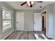 Bright bedroom with grey walls, wood-look floors, and ceiling fan at 6082 Ledgewood Dr, Forest Park, GA 30297