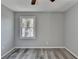 Spacious bedroom with ceiling fan and gray walls at 6082 Ledgewood Dr, Forest Park, GA 30297