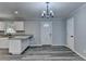 Bright dining area with chandelier and hardwood-look floors at 6082 Ledgewood Dr, Forest Park, GA 30297