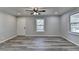 Living room with grey walls, vinyl plank floors, and ceiling fan at 6082 Ledgewood Dr, Forest Park, GA 30297