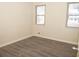 Bright bedroom with two windows and wood-look flooring at 608 Woodknoll Ct, Jonesboro, GA 30238