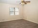 Spacious bedroom featuring wood-look floors and a ceiling fan at 608 Woodknoll Ct, Jonesboro, GA 30238