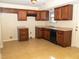 Kitchen boasts dark wood cabinets, granite counters, and tile floors at 608 Woodknoll Ct, Jonesboro, GA 30238