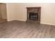 Living room with wood-look flooring and a stone fireplace at 608 Woodknoll Ct, Jonesboro, GA 30238