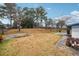 Large backyard with grassy area, patio, and mature trees at 747 Bethesda School Rd, Lawrenceville, GA 30044
