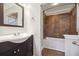 Updated bathroom with dark brown tile shower and bathtub at 747 Bethesda School Rd, Lawrenceville, GA 30044