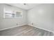 Simple bedroom with grey laminate flooring and window at 747 Bethesda School Rd, Lawrenceville, GA 30044
