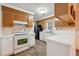 Kitchen features brown cabinets, white countertops, and tile floor at 747 Bethesda School Rd, Lawrenceville, GA 30044