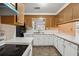 Kitchen with brown cabinets, white countertops and appliances at 747 Bethesda School Rd, Lawrenceville, GA 30044